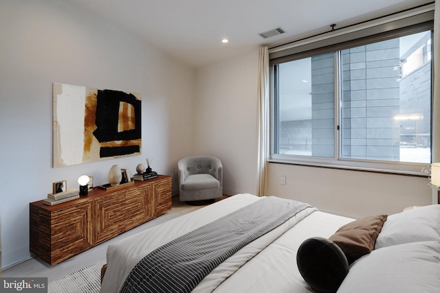 bedroom with visible vents, recessed lighting, and concrete floors