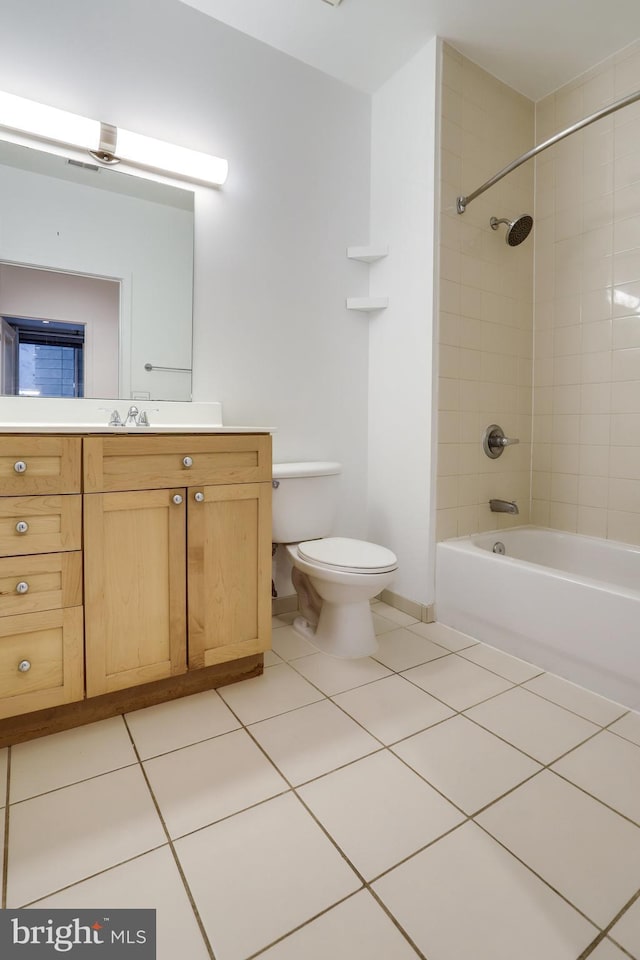 full bathroom featuring tile patterned flooring, baseboards, washtub / shower combination, toilet, and vanity