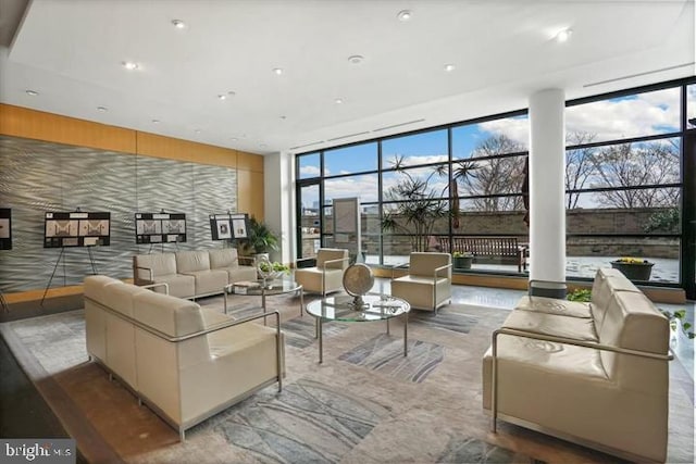 living area featuring plenty of natural light and floor to ceiling windows