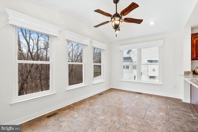 unfurnished sunroom with lofted ceiling, visible vents, and ceiling fan