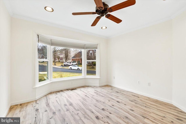 spare room with ornamental molding, recessed lighting, wood finished floors, and baseboards