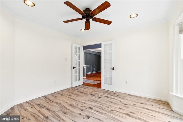 spare room featuring french doors, wood finished floors, and crown molding