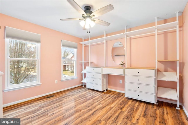 unfurnished bedroom featuring visible vents, baseboards, and wood finished floors