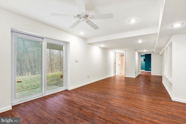 empty room featuring plenty of natural light, wood finished floors, and baseboards