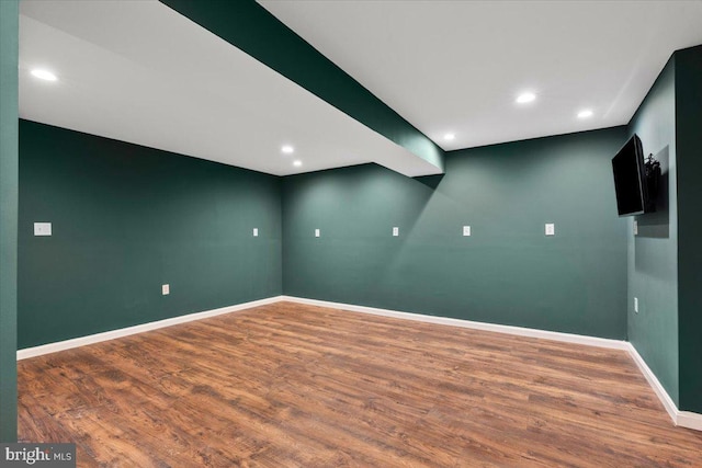 spare room with recessed lighting, wood finished floors, and baseboards