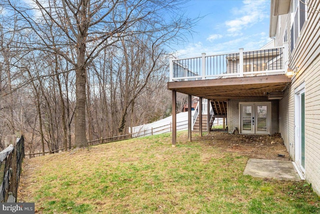 view of yard featuring french doors, fence, a deck, and stairs