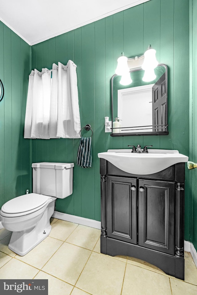 bathroom with baseboards, vanity, toilet, and tile patterned floors