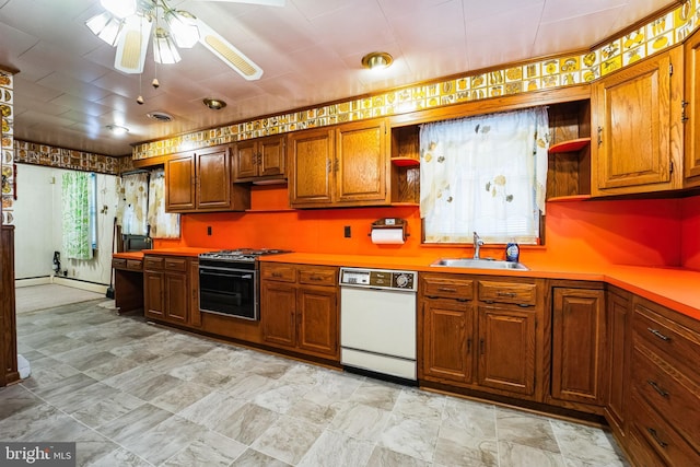 kitchen featuring brown cabinetry, gas range, white dishwasher, open shelves, and a sink