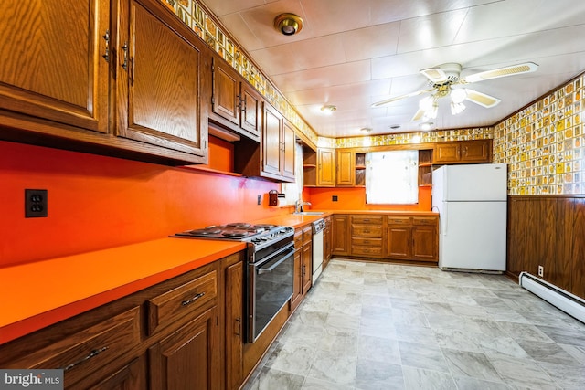 kitchen with a baseboard heating unit, freestanding refrigerator, dishwasher, open shelves, and gas stove