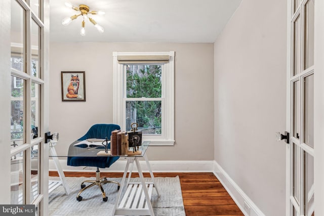 office area with french doors, wood finished floors, and baseboards