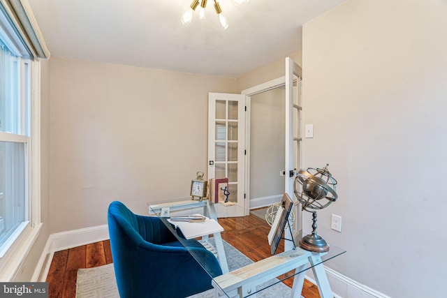 office space featuring baseboards and wood finished floors