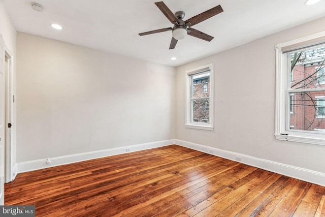 spare room featuring hardwood / wood-style flooring, ceiling fan, baseboards, and recessed lighting