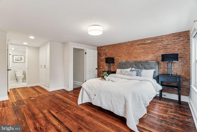 bedroom with a wood stove, brick wall, baseboards, and dark wood finished floors