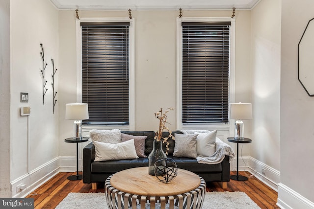 living area with baseboards and hardwood / wood-style floors