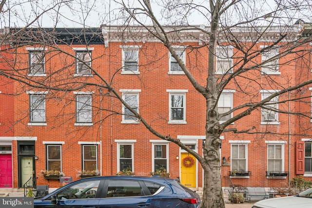 townhome / multi-family property featuring brick siding