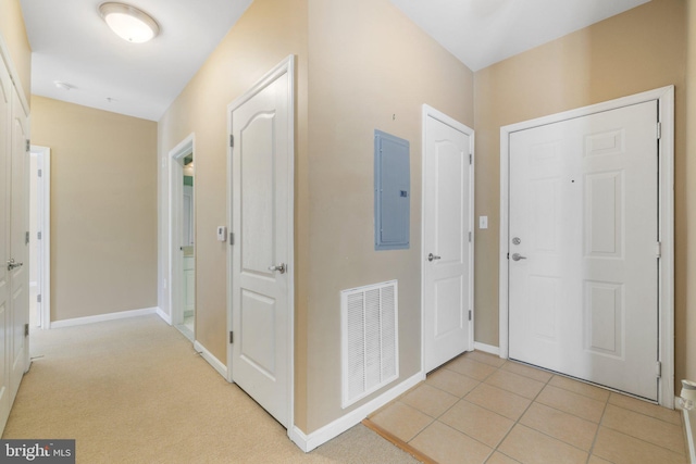 foyer featuring electric panel, visible vents, baseboards, and light tile patterned flooring