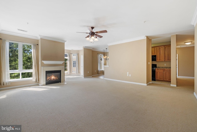 unfurnished living room with baseboards, crown molding, visible vents, and light colored carpet