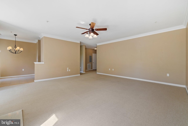 empty room featuring baseboards, crown molding, and light colored carpet