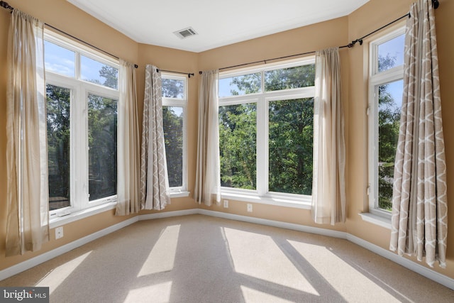 unfurnished sunroom featuring a healthy amount of sunlight and visible vents