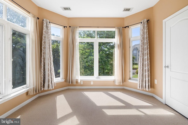 interior space with a healthy amount of sunlight and visible vents