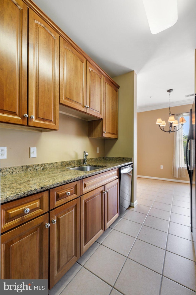 kitchen featuring brown cabinetry, ornamental molding, light tile patterned flooring, a sink, and dishwashing machine