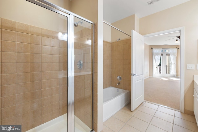 bathroom with a bathtub, french doors, a tile shower, vanity, and tile patterned floors