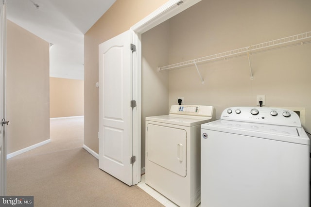 laundry room with light carpet, laundry area, baseboards, and washer and dryer