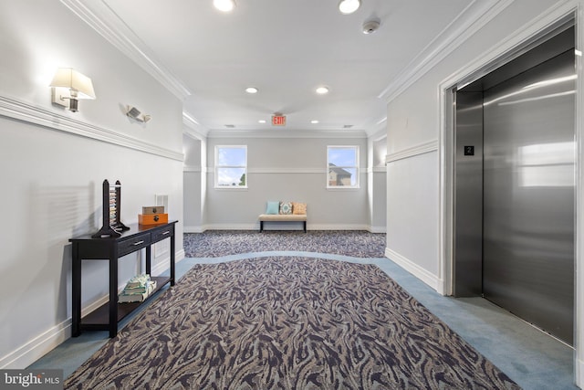 hall featuring elevator, baseboards, crown molding, and carpet flooring