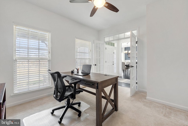 office space featuring light carpet, a healthy amount of sunlight, baseboards, and french doors