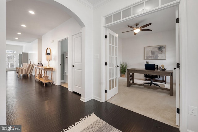 interior space featuring arched walkways, recessed lighting, ceiling fan, wood finished floors, and baseboards