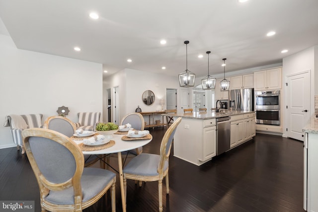 dining space with recessed lighting and dark wood finished floors