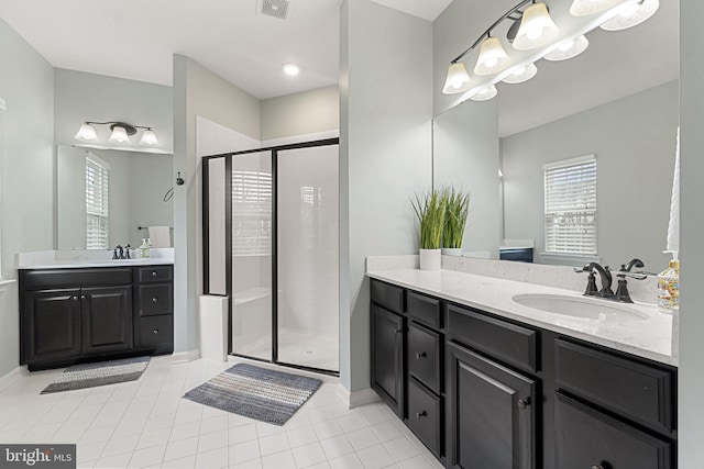 bathroom with plenty of natural light, a shower stall, and a sink