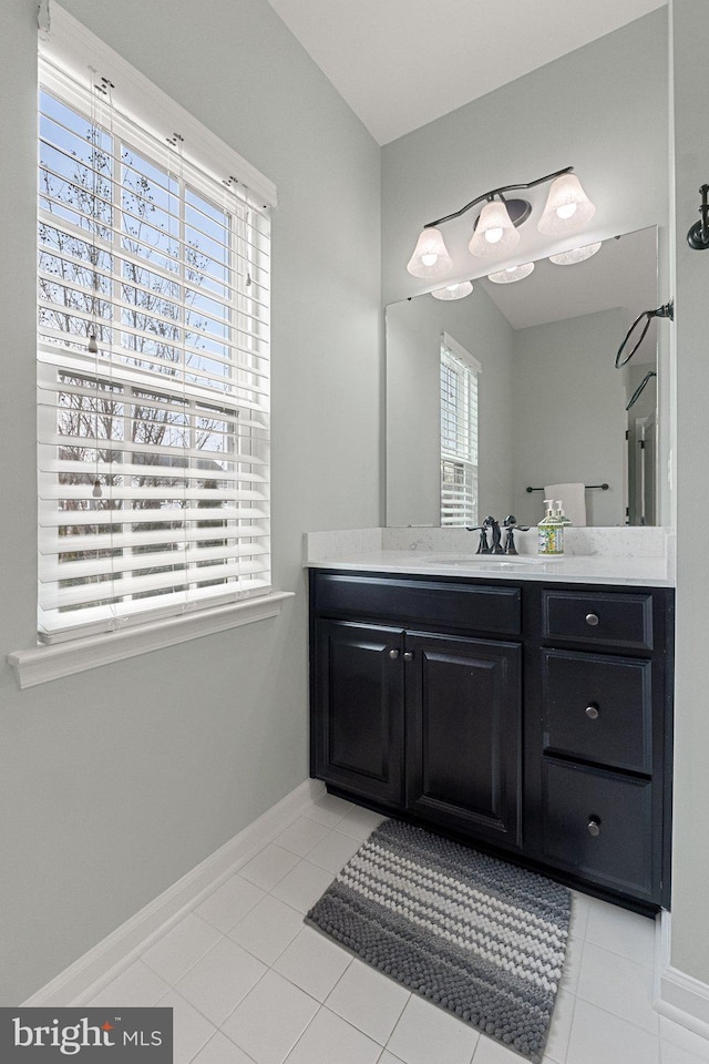 bathroom featuring tile patterned floors, vanity, and baseboards