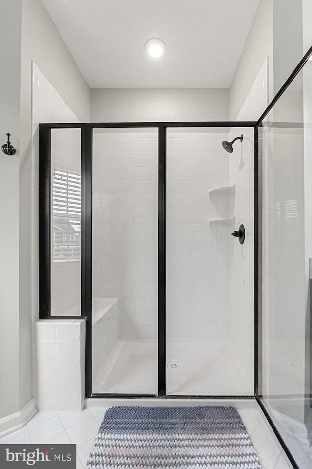 full bath featuring a stall shower and tile patterned floors