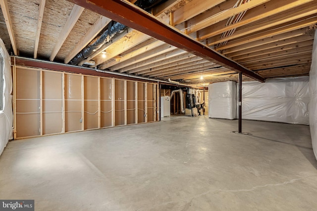 unfinished basement featuring water heater