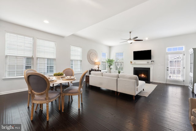 dining area with recessed lighting, dark wood-type flooring, a fireplace with flush hearth, a ceiling fan, and baseboards