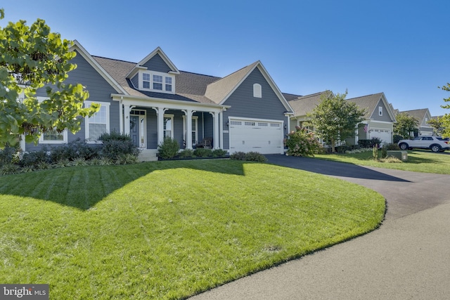 view of front of property featuring driveway, covered porch, and a front yard