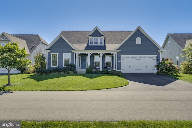 view of front facade featuring an attached garage, aphalt driveway, and a front yard