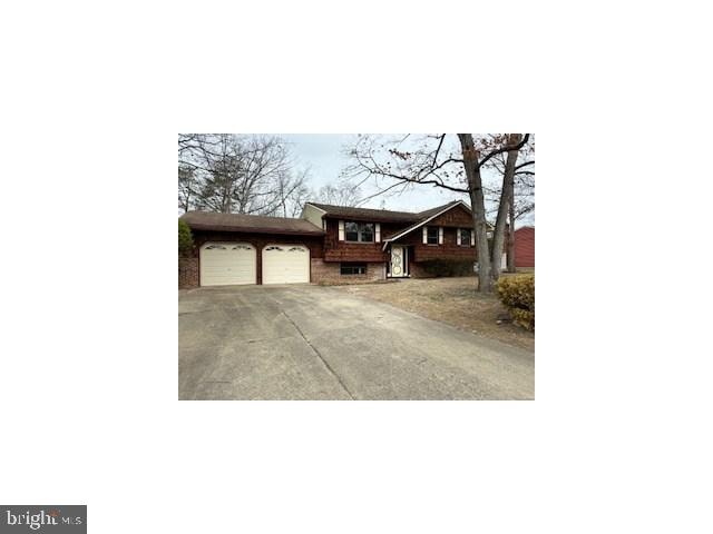 view of front of home featuring driveway and an attached garage