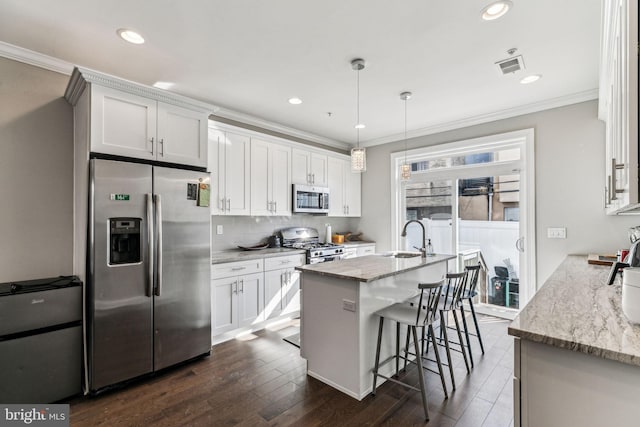 kitchen featuring stainless steel appliances, decorative backsplash, and crown molding