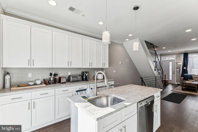 kitchen featuring dark wood finished floors, tasteful backsplash, visible vents, a sink, and dishwasher