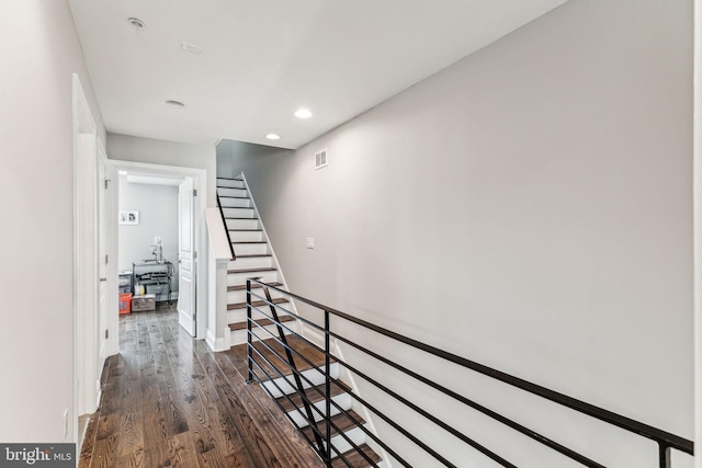 stairs featuring baseboards, visible vents, wood finished floors, and recessed lighting