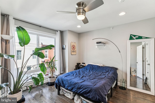 bedroom with baseboards, wood finished floors, a ceiling fan, and recessed lighting