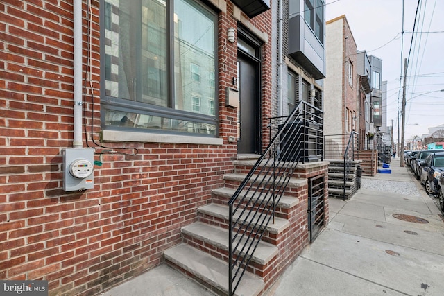 entrance to property with brick siding