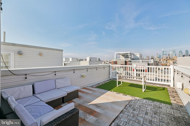 view of patio / terrace with outdoor lounge area, a city view, and a balcony