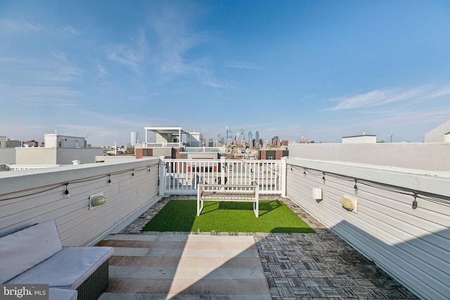 view of yard featuring a view of city and a balcony