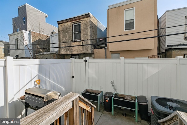 exterior space with a fenced backyard and central AC unit