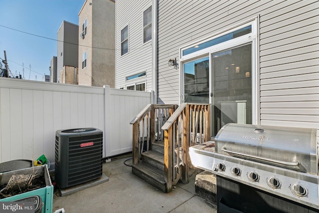 view of patio / terrace with fence, central AC unit, and grilling area