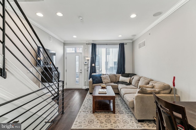 living area featuring stairs, visible vents, dark wood-type flooring, and ornamental molding