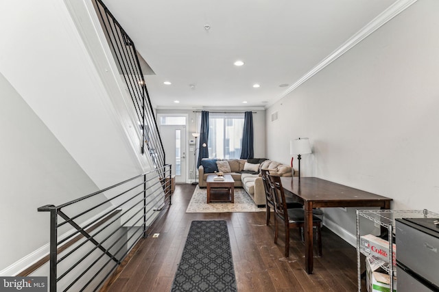 interior space with stairway, baseboards, ornamental molding, and hardwood / wood-style floors